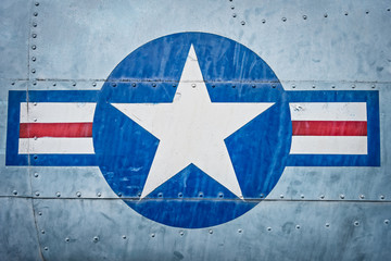 Military plane with star and stripe sign.