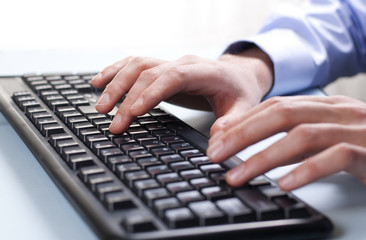 Businessman typing on a computer keyboard