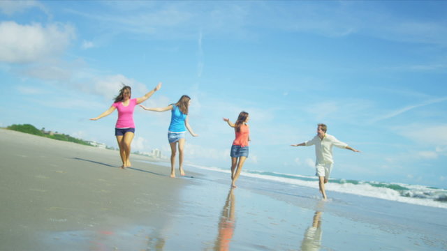 Carefree Caucasian Family Barefoot Beach