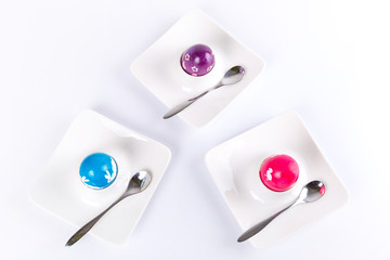Colorful Easter eggs on plates with spoons