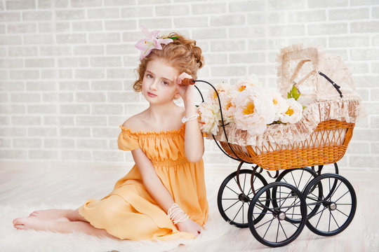 Girl In Orange Dress With Vintage Pram