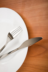 knife and fork on white plate