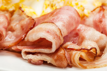 Close-up bacon and scrambled eggs. Selective focus.