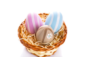 Fototapeta na wymiar Colorful Easter eggs in the basket over white background