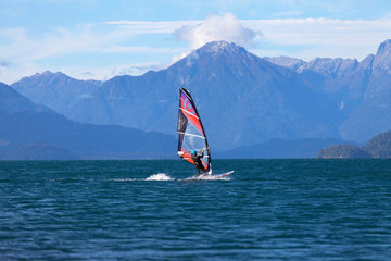 Windsurfer on mountain lake