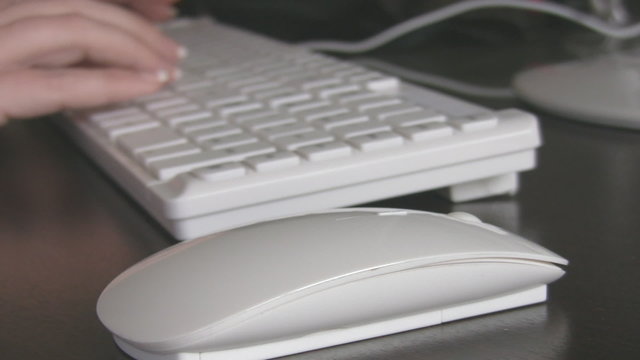 Close up of a hand typing on keyboard.