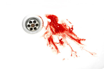 blood and spit splatter drains in a white sink