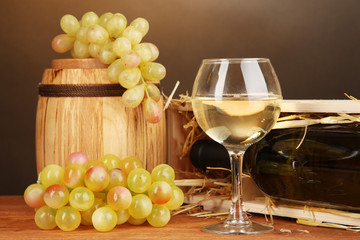 Wooden case with wine bottle, barrel, wineglass and grape