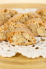 Aromatic cookies cantuccini on wooden plate close-up