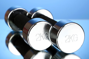 Dumbbells at 2 kg on blue background