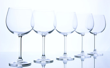 Empty wine glasses arranged and isolated on white