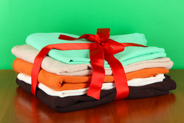 Pile of clothing with red ribbon and bow