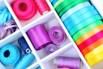 Material for sewing in white wooden box closeup