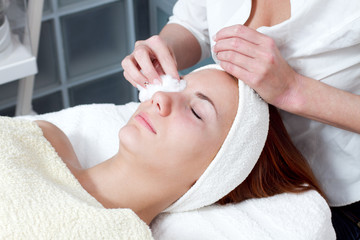 Fototapeta na wymiar young woman having facial beauty treatment at beauty salon