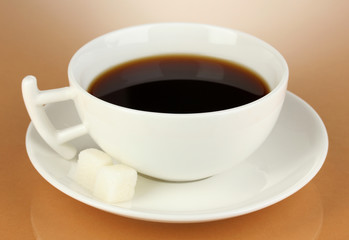 A cup of strong coffee on beige background