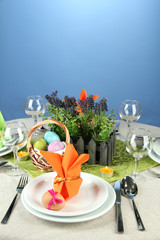 Easter table setting on color background