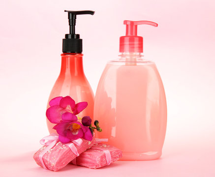 Liquid And Hand-made Soaps On Pink Background