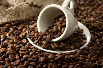 Cup with coffee beans, close up