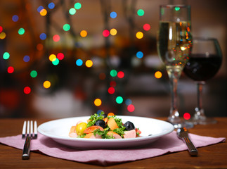 Tasty salad on dark background with bokeh  defocused lights