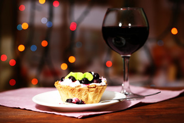 Tasty blackberry cake and glass of red wine,