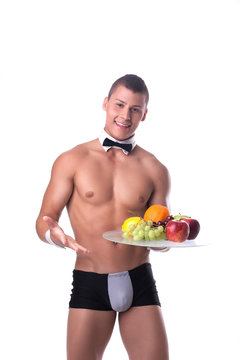 Handsome smiling man holding tray with fruit
