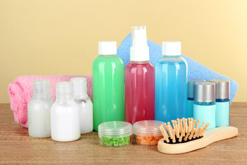Hotel amenities kit on table on beige background