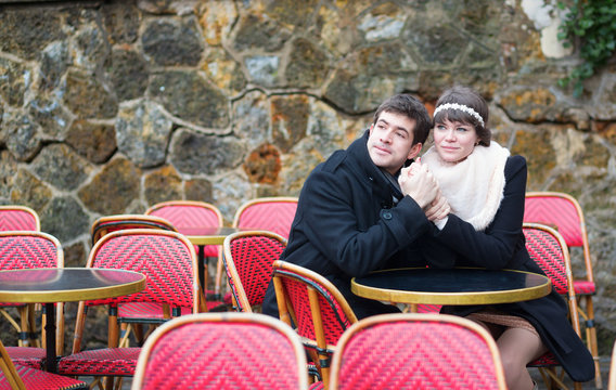 Dating couple in a Parisian outdoor cafe