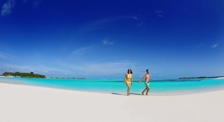 happy young  couple enjoying summer on beach
