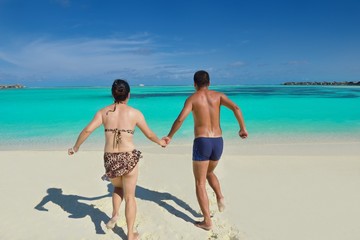 Fototapeta premium happy young couple enjoying summer on beach