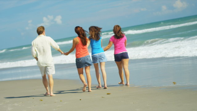 Happy Caucasian Family Group Walking Beach
