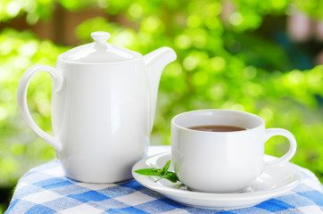 Cup of tea on nature background