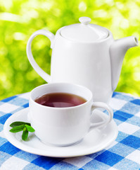 Cup of tea on nature background