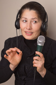 Asian woman listening to music on headphones