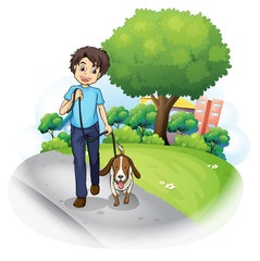 Een jongen met een hond die over straat loopt
