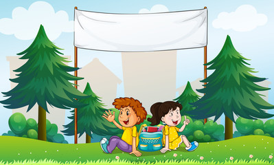 A girl and a boy sitting in the hill with an empty signage