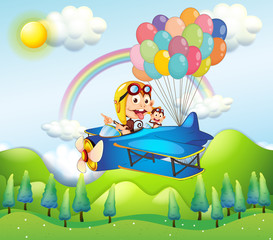 Two monkeys riding in a plane with colorful balloons