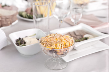 Salad with seafood in a salad dish at the dinner table