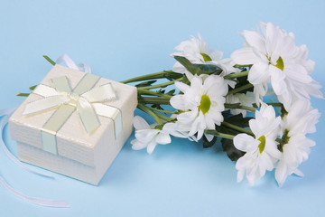 Bouquet of white chrysanthemums and gift boxe