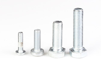 Four silver metal screws isolated on white background.