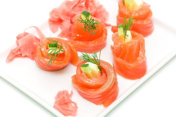 Salmon rolls with cheese and cucumber on white background