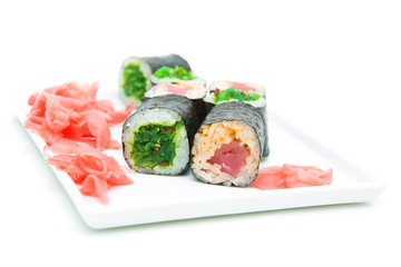 sushi and pickled ginger on a plate on a white background