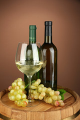 Composition of wine bottles, glass of white wine, grape