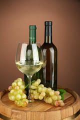 Fototapeta premium Composition of wine bottles, glass of white wine, grape