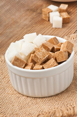 Close-up of cubes of brown and white sugar