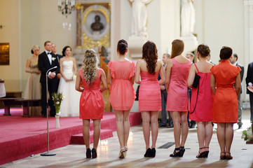 Row of bridesmaids in coral dresses