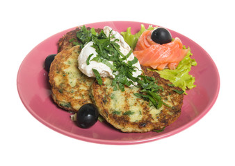 Roasted cutlets of potato with salmon on a plate