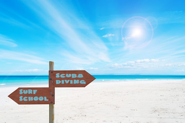 desert beach in paradise with wooden sign