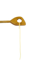 spaghetti hanging on a wooden spoon, isolated