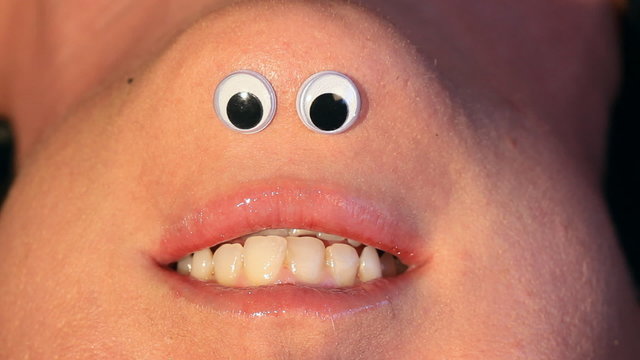 Mrs Chinigan talks.  Cartoon eyes on inverted female face.