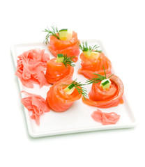 rolls of trout with cucumber on a white background
